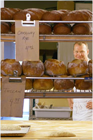 A baker making bread in a bakery