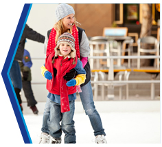 A mother and daughter iceskating.