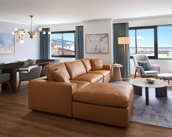 Living and dining room view of a Marriott Bonvoy property suite.