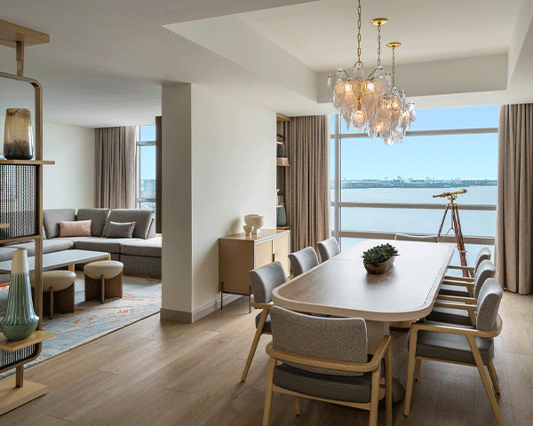 The living and dining room view of a Marriott Bonvoy suite.