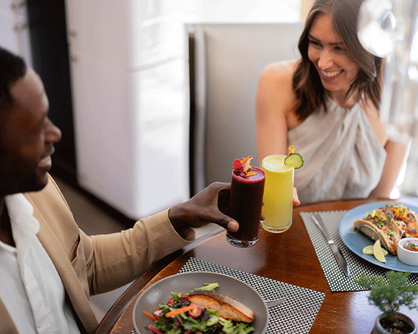 Couple enjoying a meal at a Marriott Bonvoy restaurant.