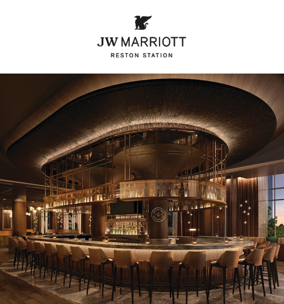 An elegant bar area in the JW Marriott Reston Station featuring a large curved bar counter, stylish seating, and warm ambient lighting. JW Marriott Reston Station logo at the top.