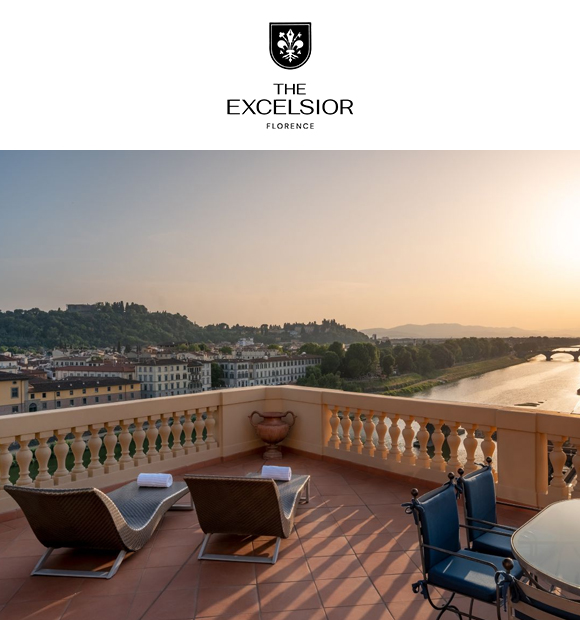 A terrace at sunset featuring two lounge chairs and a table overlooking a river and cityscape in Florence, with a logo for The Excelsior Hotel at the top.