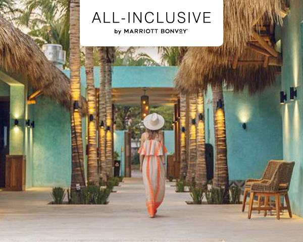 A woman admiring the outdoor courtyard of a hotel.