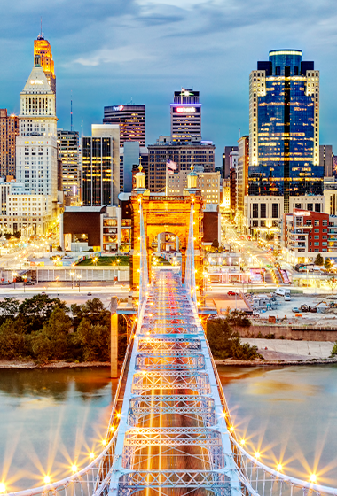 Nighttime view of a bridge going into Cincinnati.