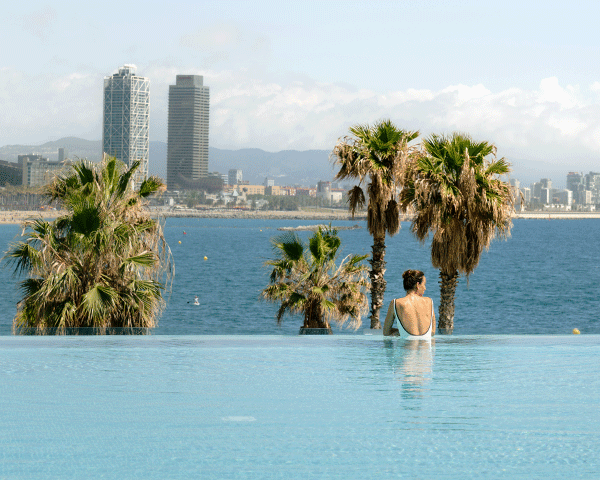Woman relaxing in a European hotel's pool.