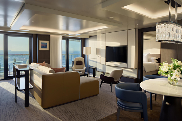 Couple lounging in private suite terrace looking out into the ocean view