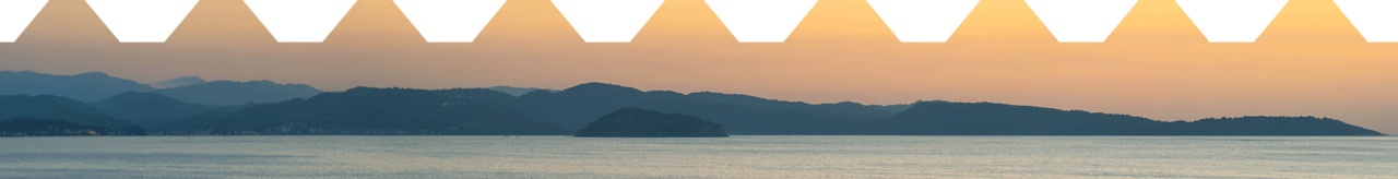 Panoramic sunset over a calm lake with layered mountain silhouettes, warm orange sky, and a bold white zigzag geometric foreground border.