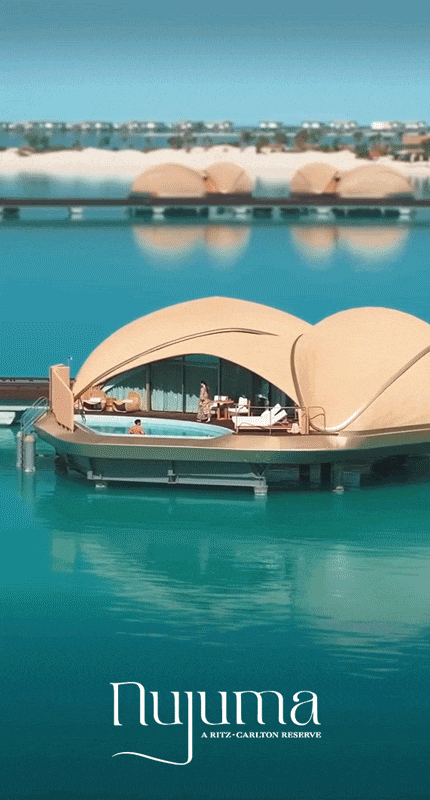 Animated GIF of a couple enjoying a hotel villa stationed upon blue turquoise waters.