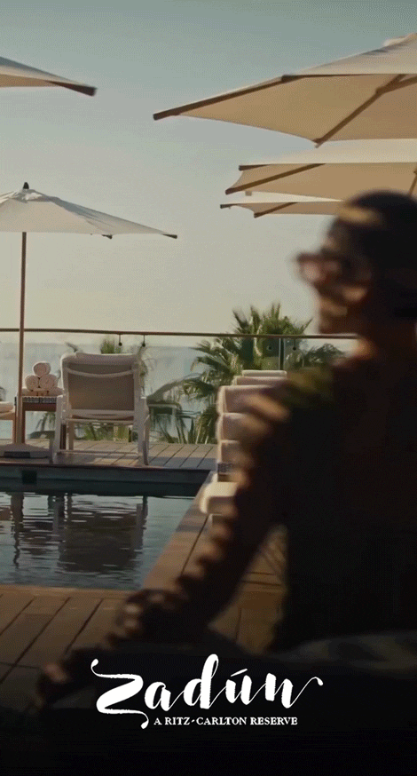 Animated GIF of a woman in a suite, waves crashing on the ocean, and a hotel pool.